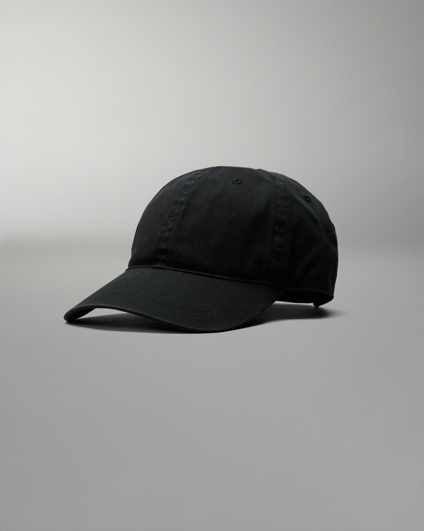Black baseball cap on a gray background