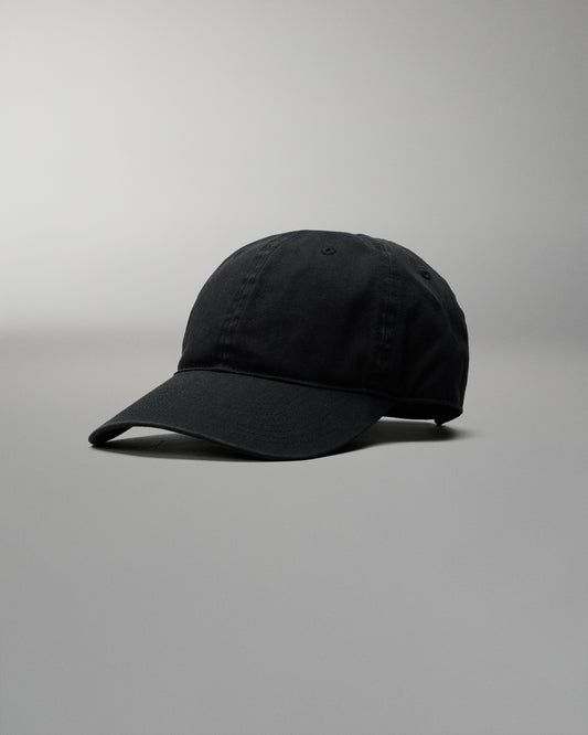 Black baseball cap on a gray background