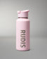 A matte light pink insulated water bottle with a matching flip-top lid, featuring the brand name 'RUDIS' printed vertically in dark gray on the front, set against a neutral gray studio background.