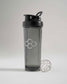 A stylish black shaker bottle with a sleek design featuring a transparent body and a metallic mixing ball beside it