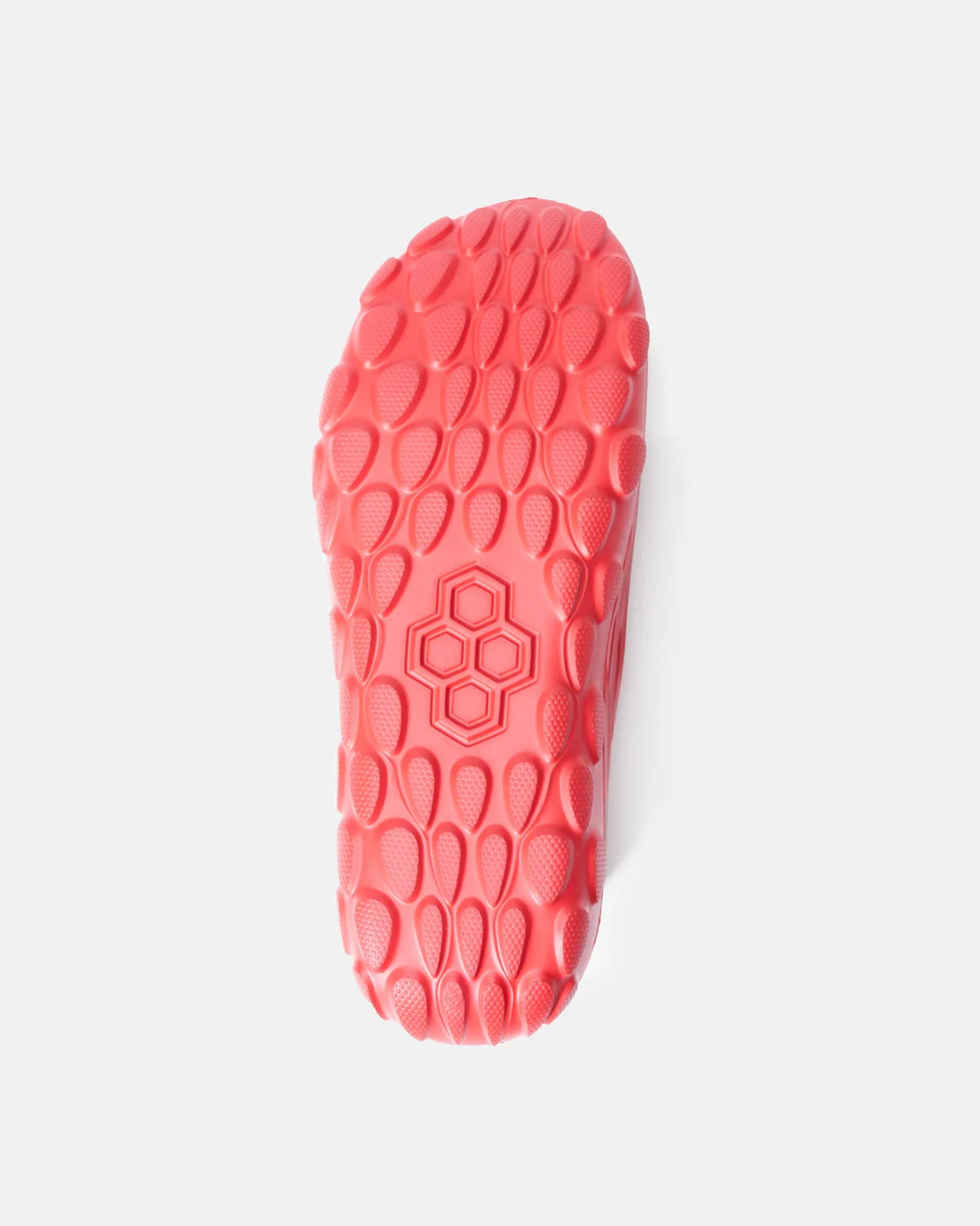 A vibrant pink shoe sole featuring a unique textured pattern designed for optimal grip and flexibility