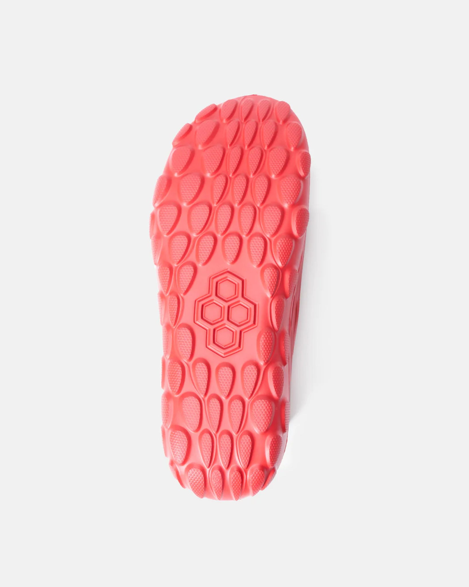 A vibrant pink shoe sole featuring a unique textured pattern designed for optimal grip and flexibility