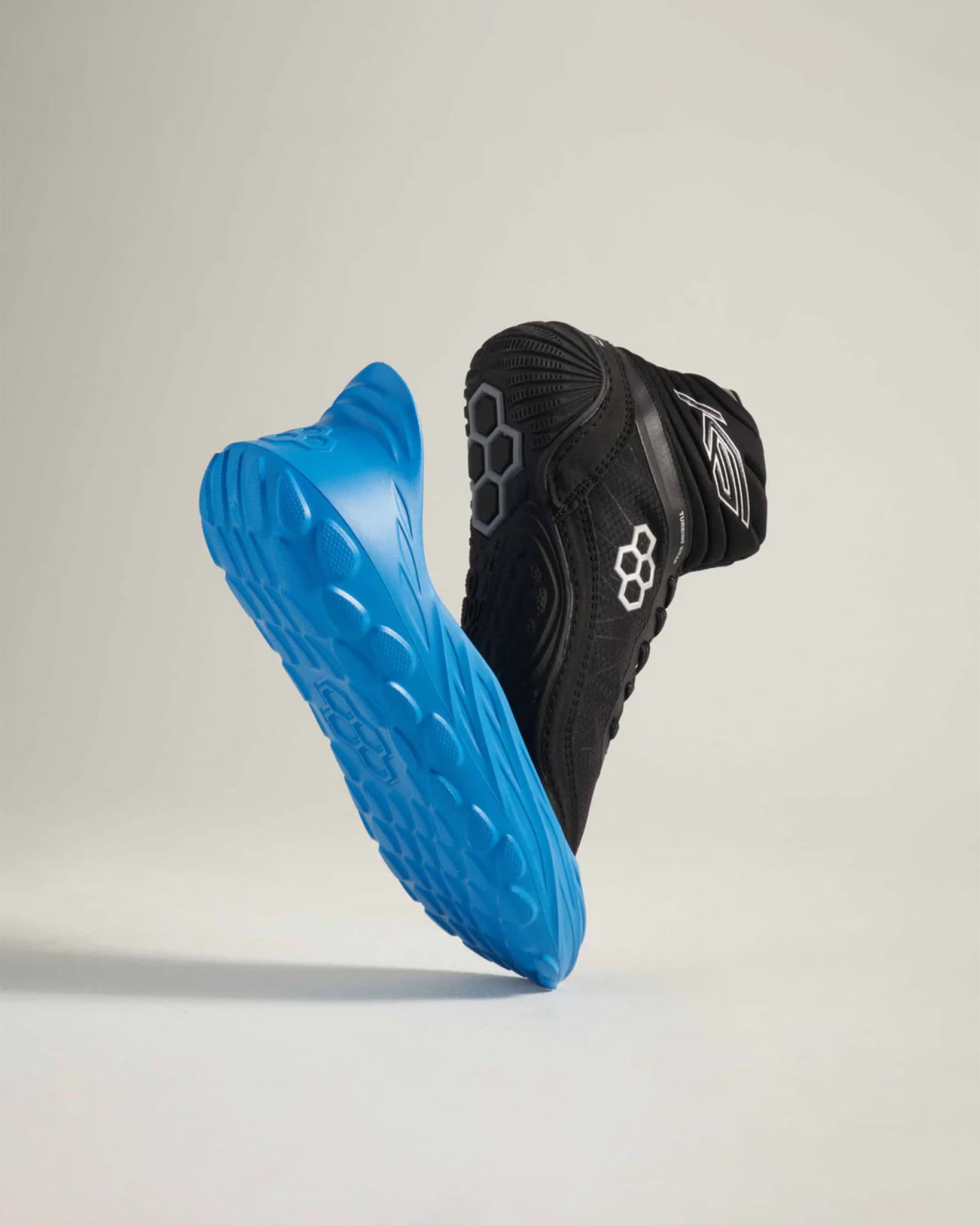 A pair of dynamic black and blue running shoes showcasing a modern design with advanced grip technology