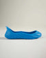 A vibrant blue shoe showcasing a unique fluid design with a textured sole suitable for casual wear