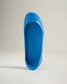 A vibrant blue shoe designed for casual and outdoor use featuring a unique streamlined silhouette and a textured sole for comfort and grip