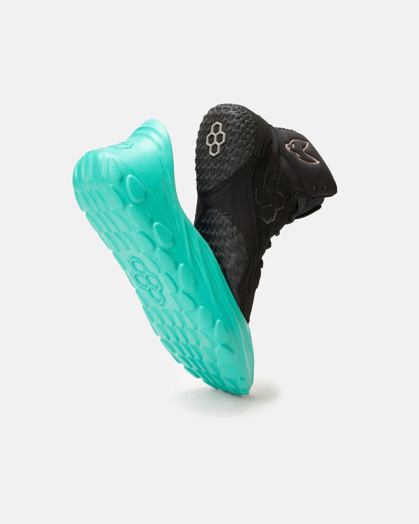 This image showcases a dynamic black athletic shoe with a striking turquoise sole emphasizing its modern design and advanced traction features