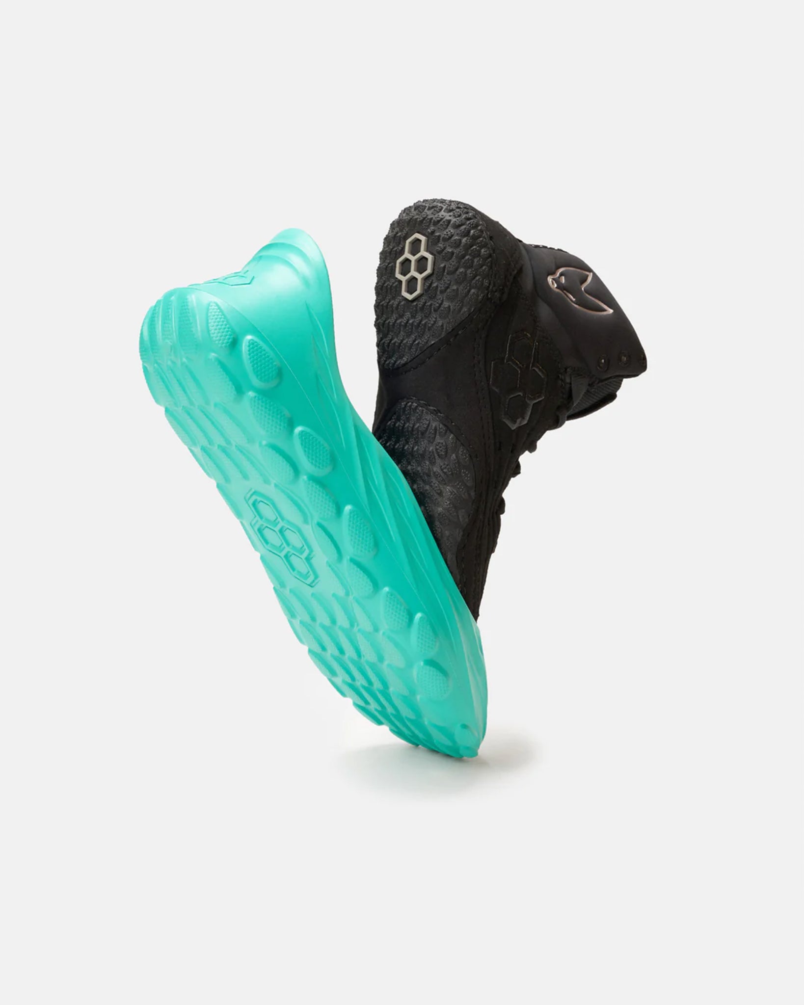 This image showcases a dynamic black athletic shoe with a striking turquoise sole emphasizing its modern design and advanced traction features
