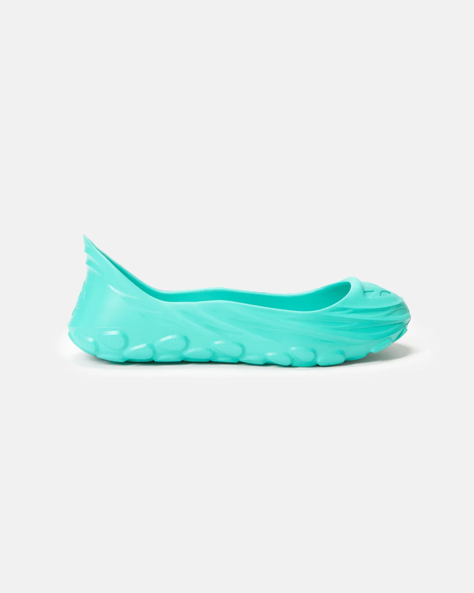 A side view of a light teal slip-on shoe with a uniquely sculpted design and textured cushioned sole