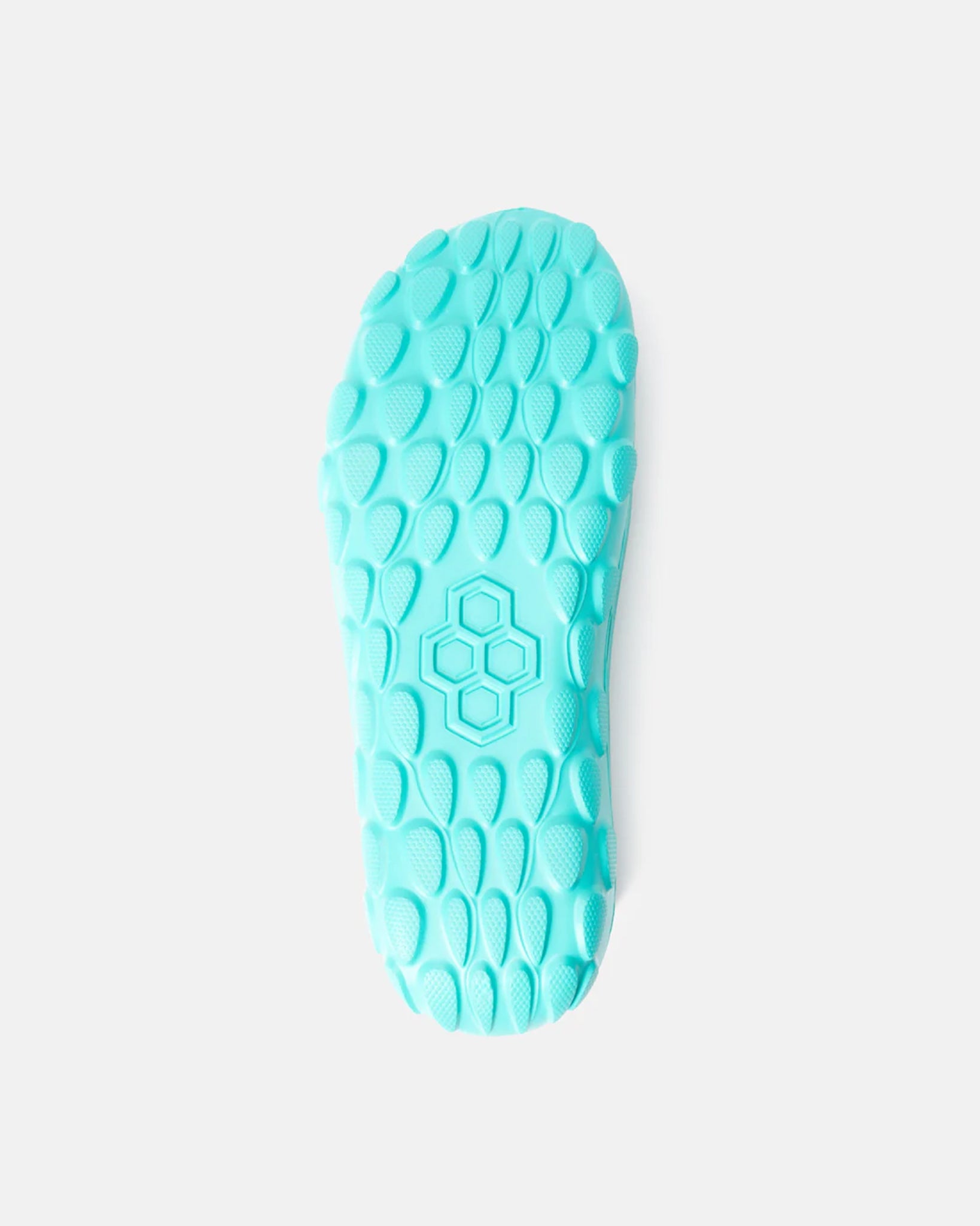 A top view of a bright turquoise sneaker sole featuring a textured grip pattern and a honeycomb design at the center