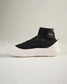 A contemporary high-top sneaker featuring a black mesh upper a neoprene collar for a snug fit and a thick white sole with textured detailing for enhanced grip
