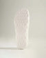 A close-up of a white shoe sole featuring a textured pattern designed for traction and support