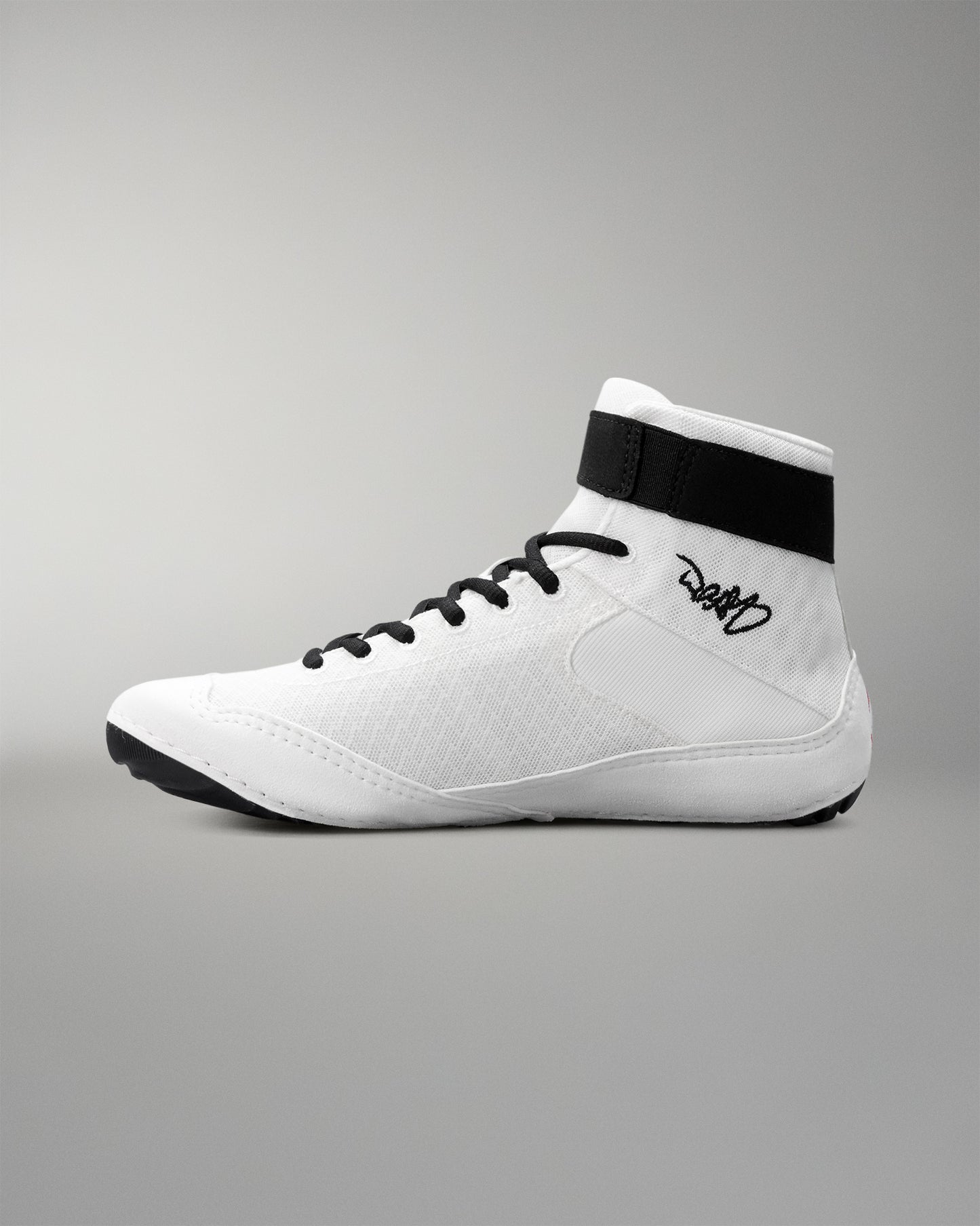 White wrestling shoe with black accents on a gray background
