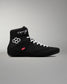 Black wrestling shoe with white laces on a gray background