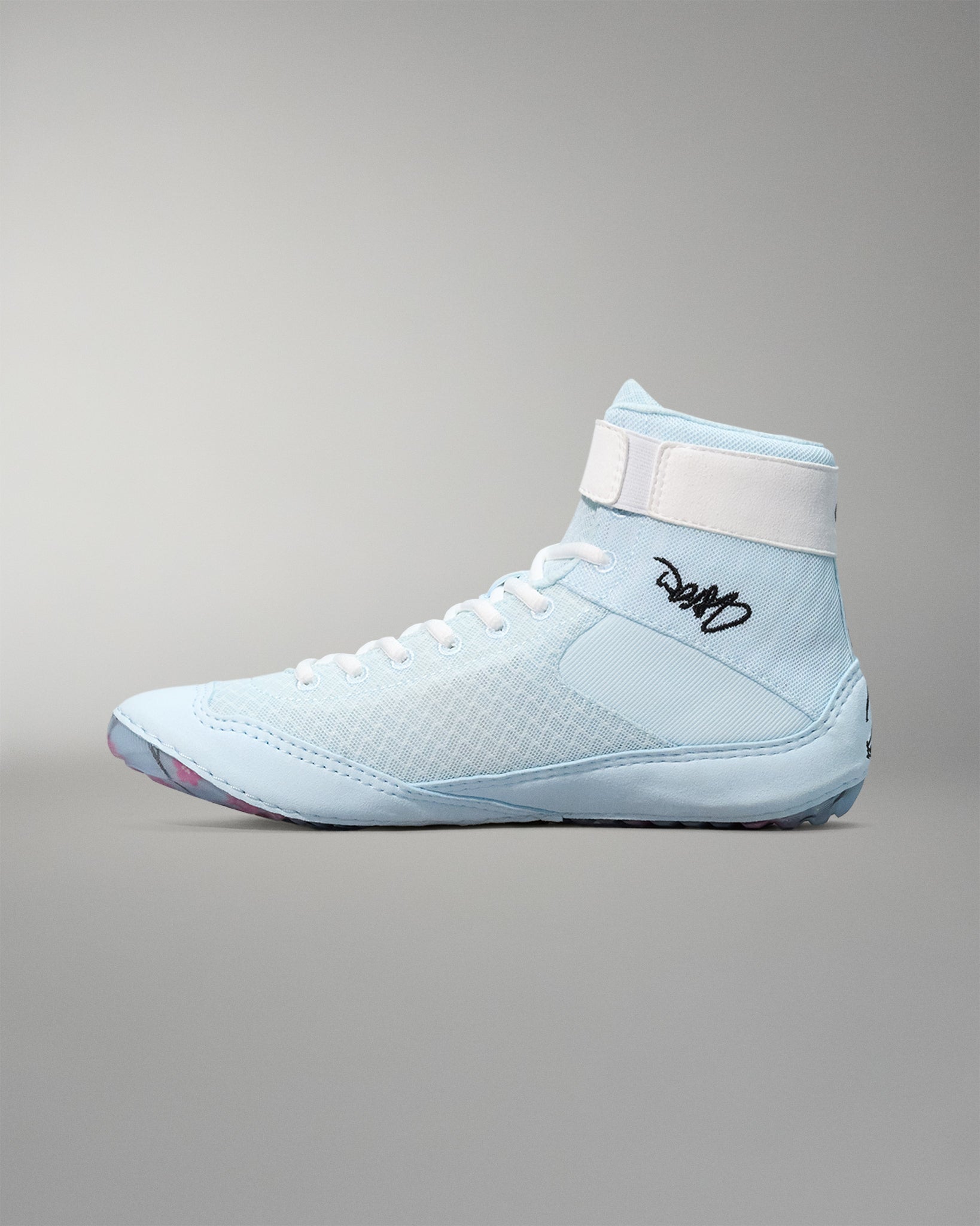 Light blue wrestling shoe with white accents on a gray background