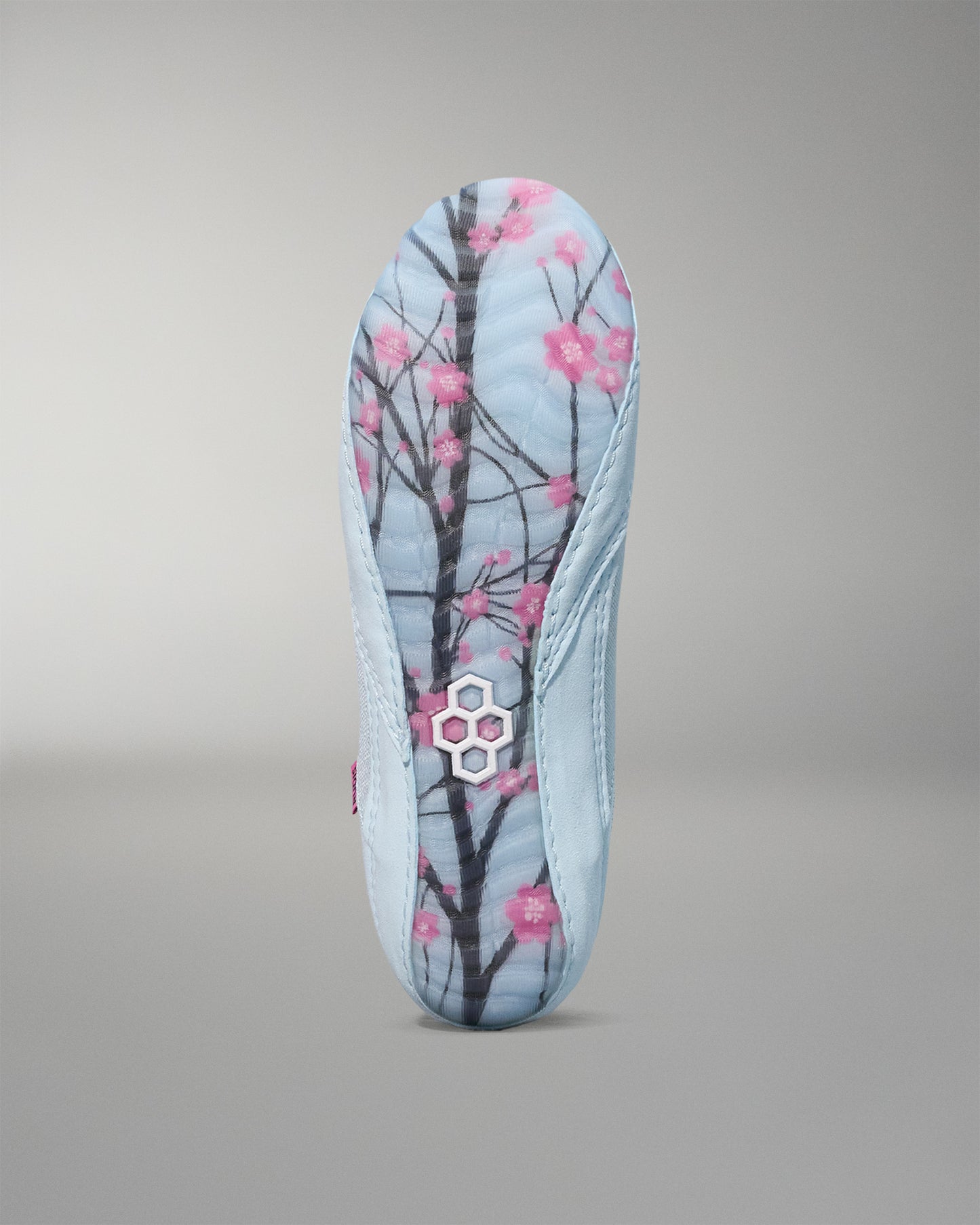 wrestling shoe insole with cherry blossom design on a gray background