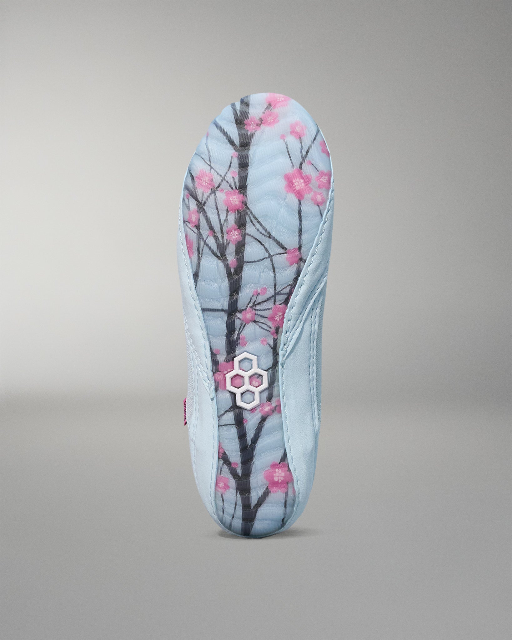 wrestling shoe insole with cherry blossom design on a gray background