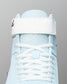 Light blue wrestling shoe with white laces on a gray background