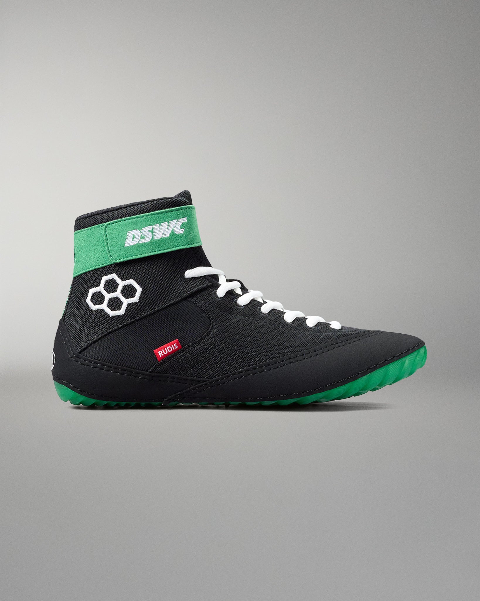 Black and green wrestling shoe with visible branding on a gray background