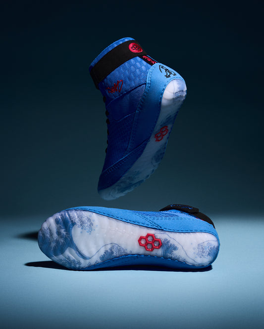 RUDIS Samurai Speed Ikigai wrestling shoes in vibrant blue, showcasing wave-inspired translucent soles, black ankle straps, and red RUDIS logos.