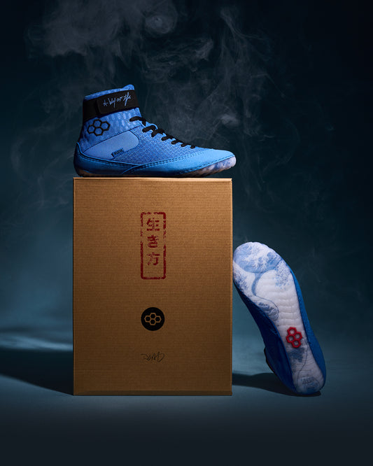 RUDIS Samurai Speed Ikigai wrestling shoe displayed on custom packaging with Japanese-inspired artwork, blue mesh upper, and translucent outsole.