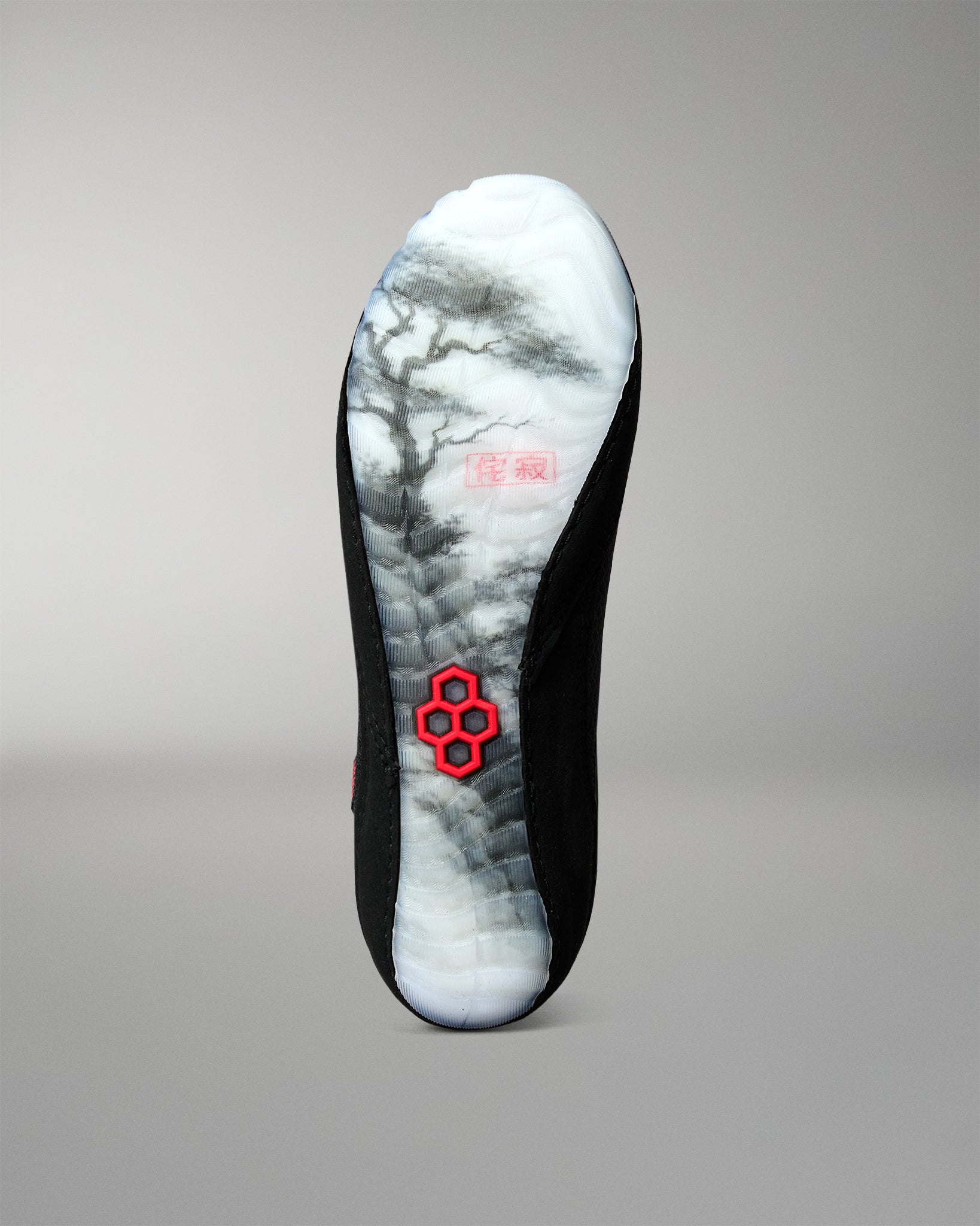 Bottom view of the RUDIS Samurai Speed Wabi-Sabi wrestling shoe, featuring a translucent outsole with black Japanese landscape artwork and a red RUDIS emblem.
