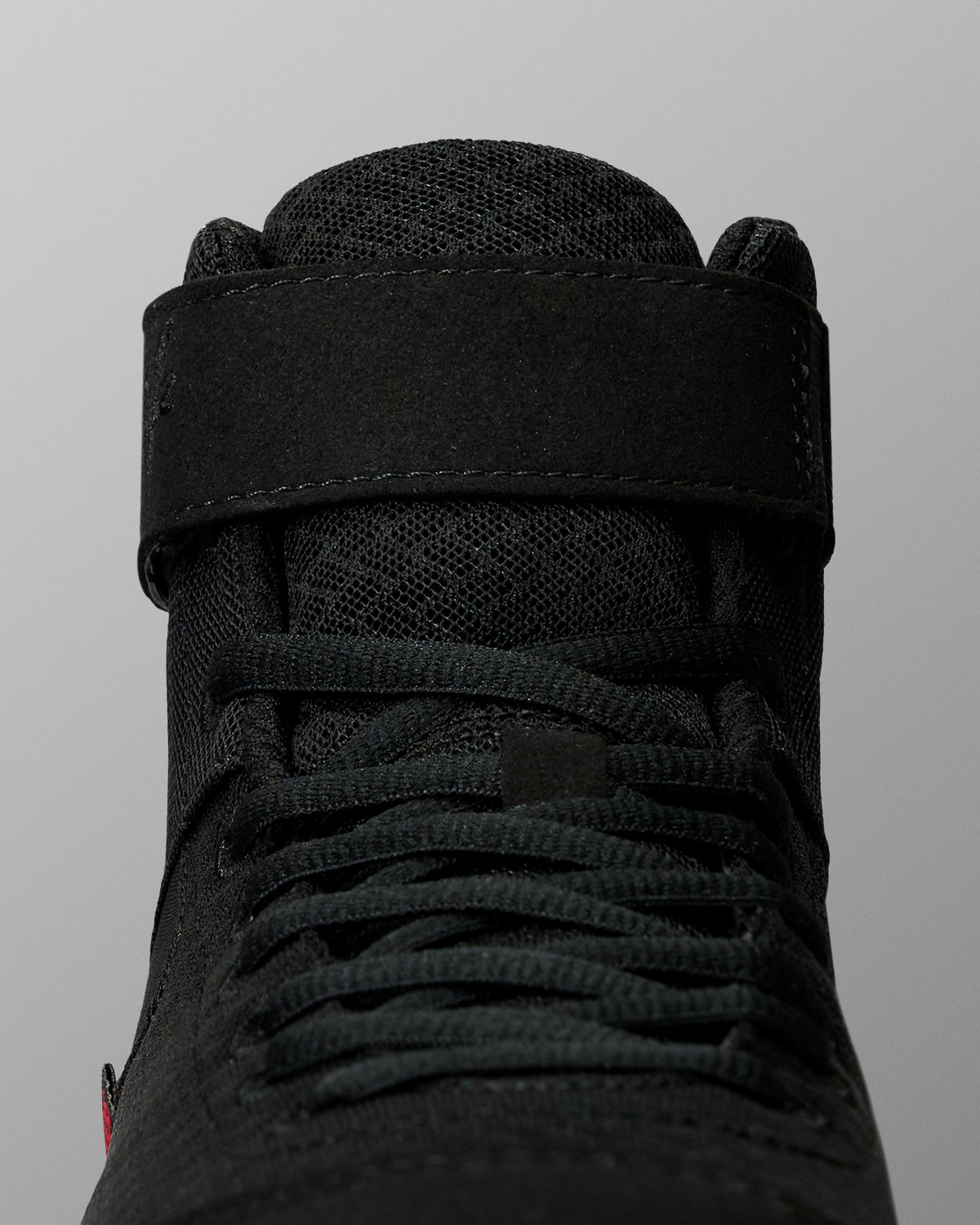 Close-up of the RUDIS Samurai Speed Wabi-Sabi wrestling shoe, highlighting black laces, textured mesh tongue, and wide ankle support strap.
