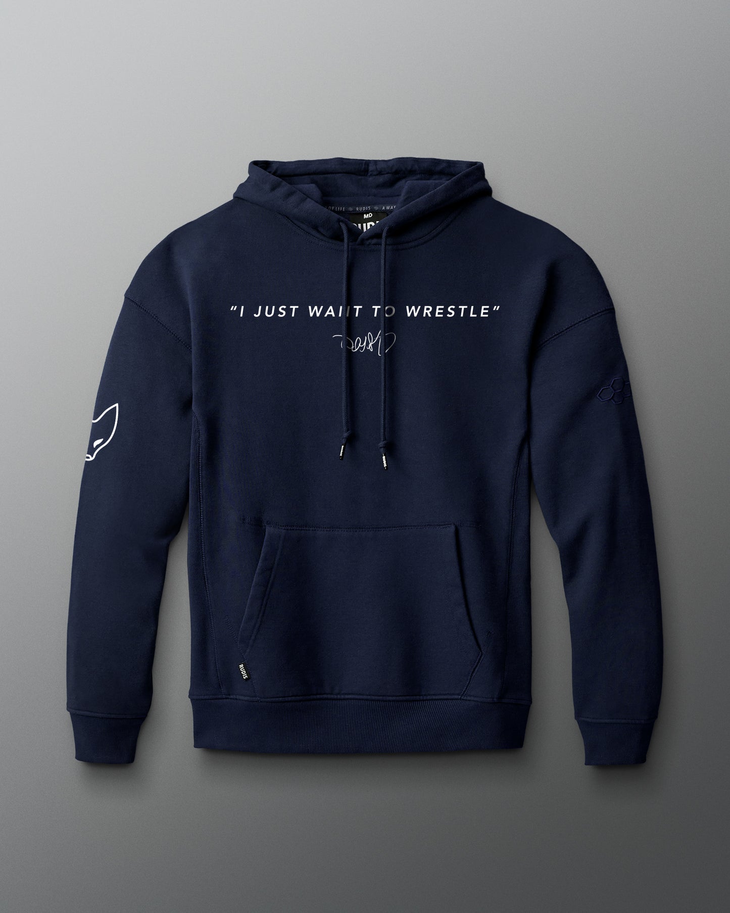 Front view of a navy hoodie featuring the phrase “I JUST WANT TO WRESTLE” in white block letters across the chest, with a signature printed below. Includes a front kangaroo pocket and subtle graphics on both sleeves.