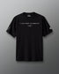 Front view of a black RUDIS t-shirt featuring the quote “I JUST WANT TO WRESTLE” in white capital letters across the chest, with a signature-style graphic underneath. The left sleeve displays a stylized fox head icon, and the right sleeve features the RUDIS hex logo.