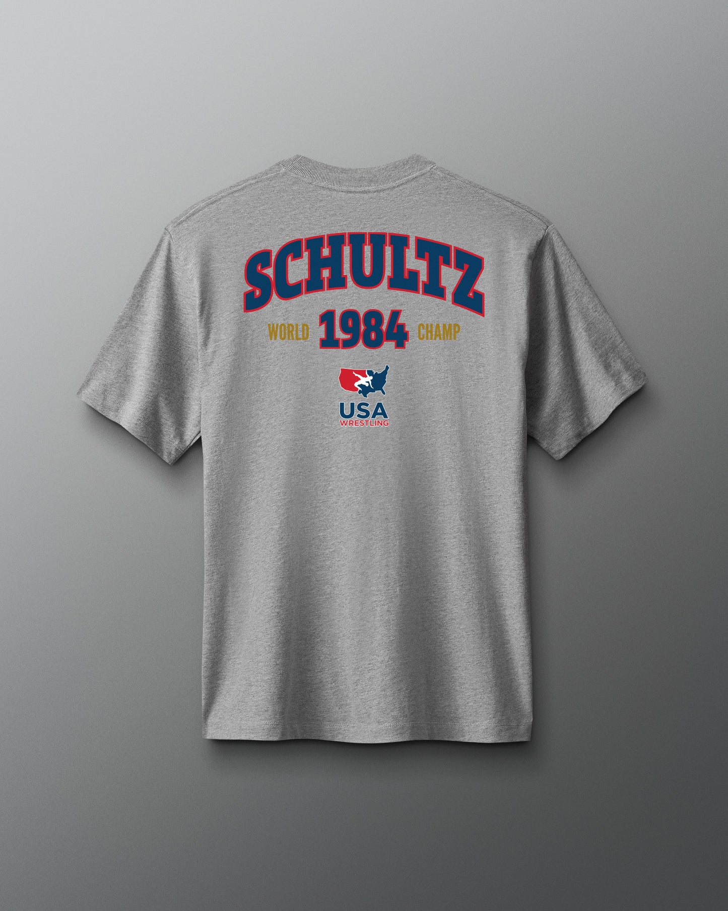 Gray t-shirt with 'Schultz 1984 World Champ USA' text on a gray background