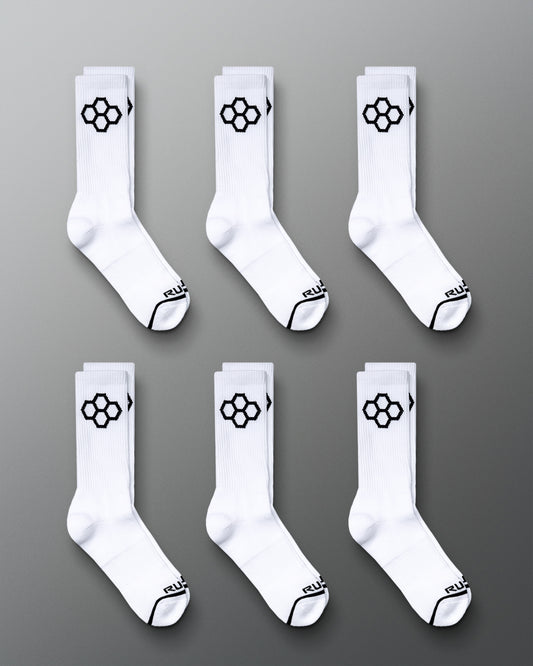 This image displays six pairs of white sports socks featuring a distinctive black hexagonal logo on the sides and black accents on the toes