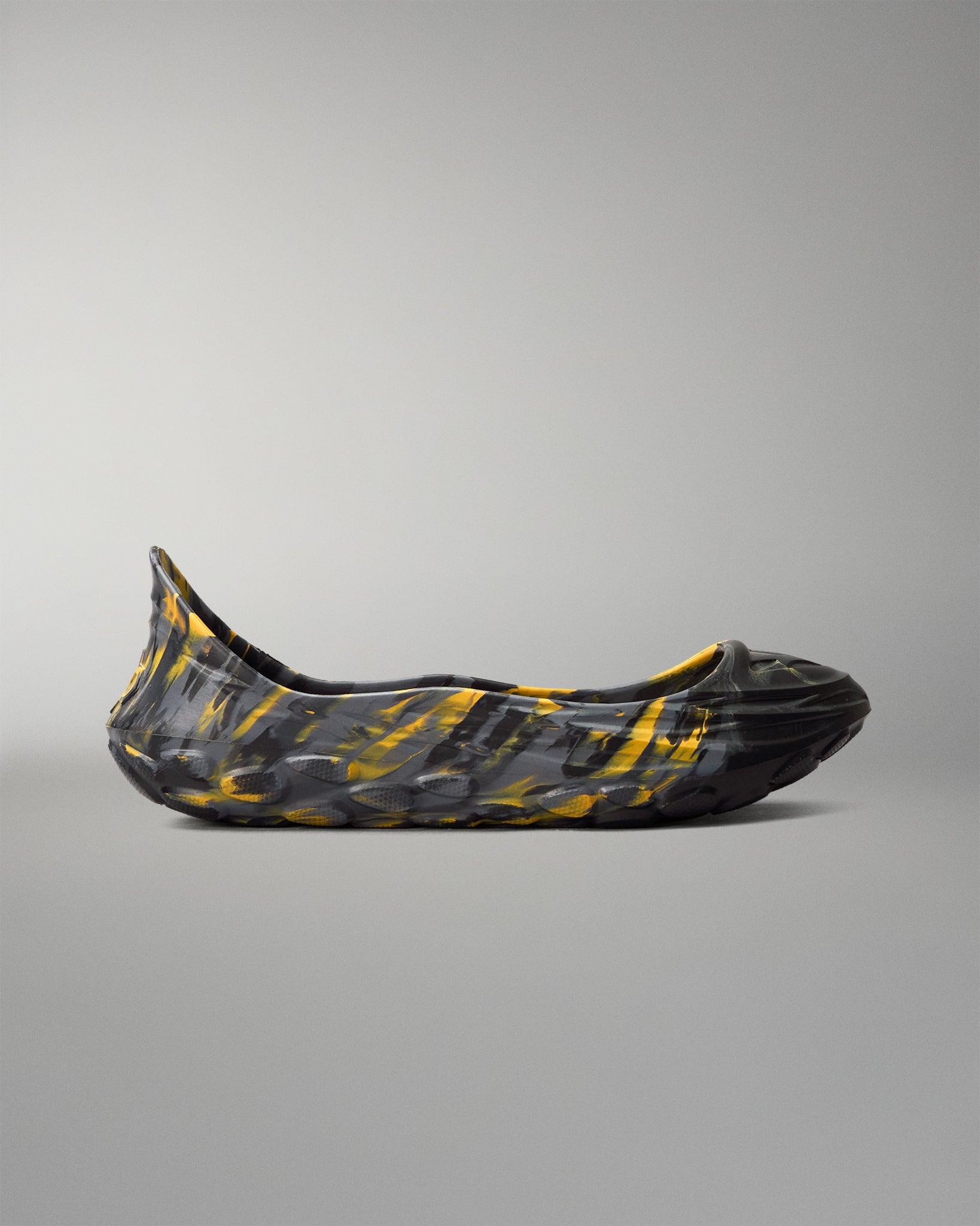 Side profile of RUDIS black and yellow wrestling shoe cover featuring a marbled design and raised protective sole.