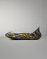 Opposite side view of the RUDIS black and yellow wrestling shoe cover with marbled yellow accents and extended heel protection.