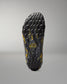 Bottom view of RUDIS black and yellow wrestling shoe cover showing the textured traction pattern and RUDIS hex logo.