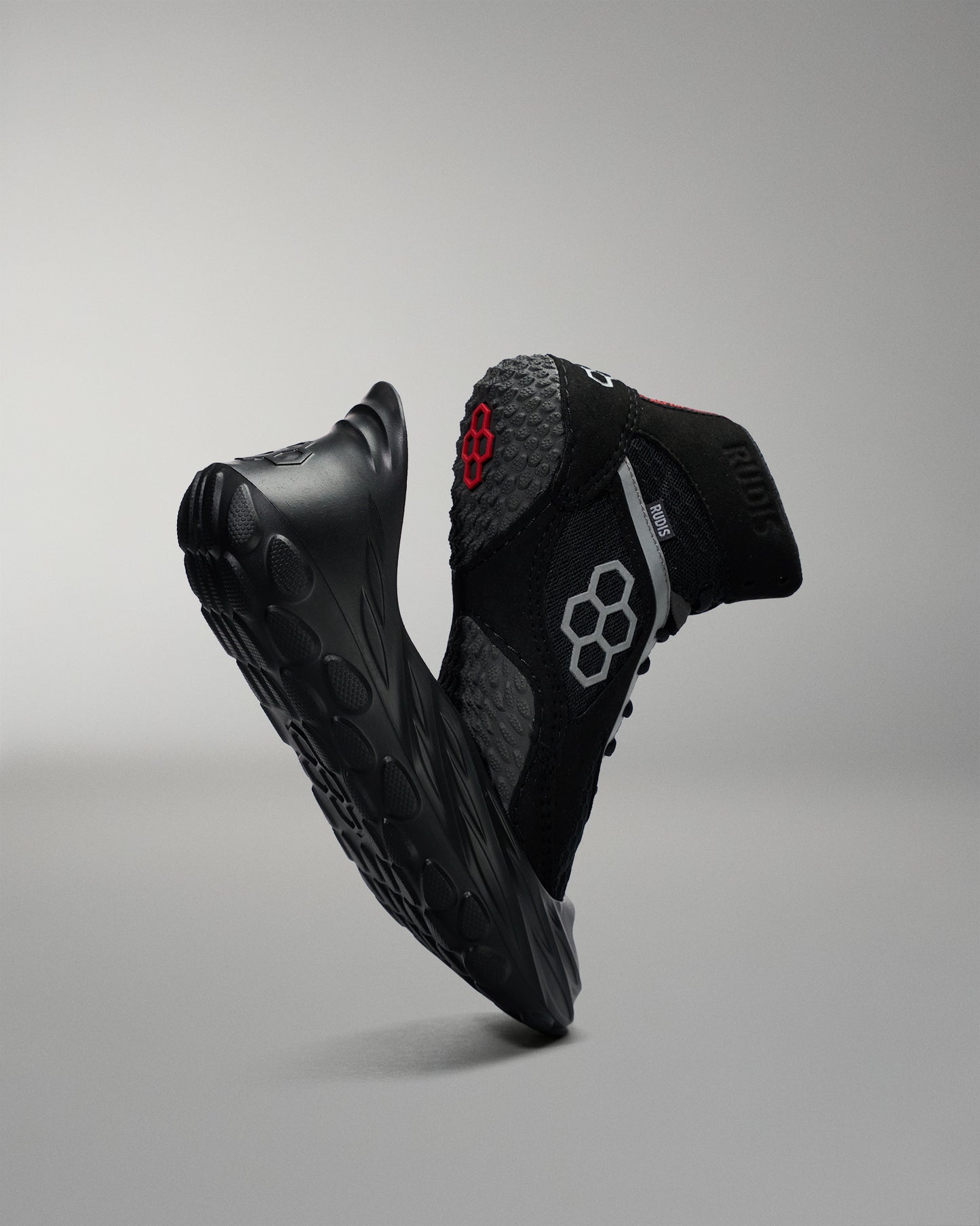 Black athletic wrestling shoe sole cover, with a wrestling shoe with a red logo on a gray background