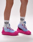 Athlete wearing RUDIS pink sole covers over blue wrestling shoes with lightweight slip-on protection design