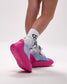 Pink and blue wrestling shoes with white socks featuring a black sock brand logo on a light gray background.