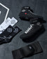 Black wrestling shoes and socks with a RUDIS brand logo on a dark textured surface