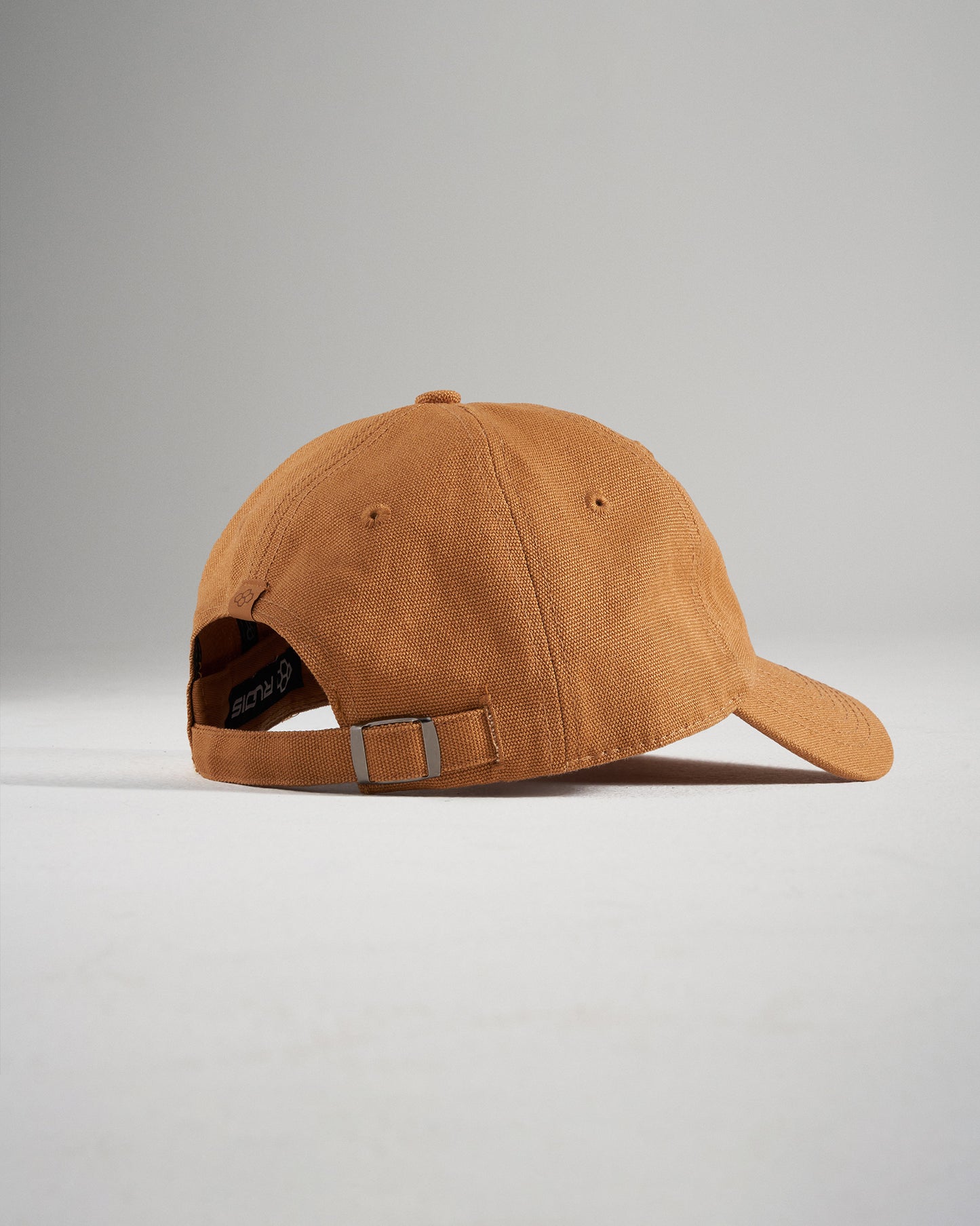 A stylish brown baseball cap with a relaxed fit featuring a soft fabric and an adjustable strap for comfort