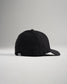 A stylish black baseball cap shown from a side angle featuring a curved brim and a subtle logo on the back