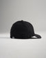 A stylish black baseball cap shown from a side angle featuring a curved brim and a subtle logo on the back