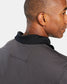 A close-up view of a mans collar and back of a striped polo shirt showcasing a stylish design and texture
