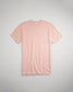 A soft pink short-sleeve t-shirt is displayed flat against a light gray background