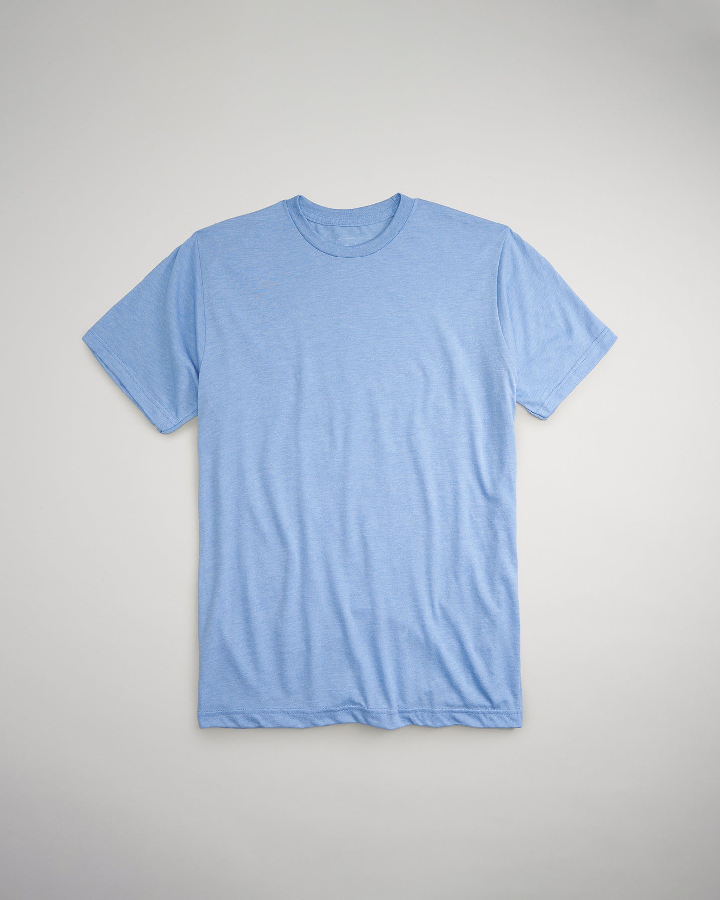 A folded blue t-shirt displayed on a light gray background showcasing a casual and comfortable style