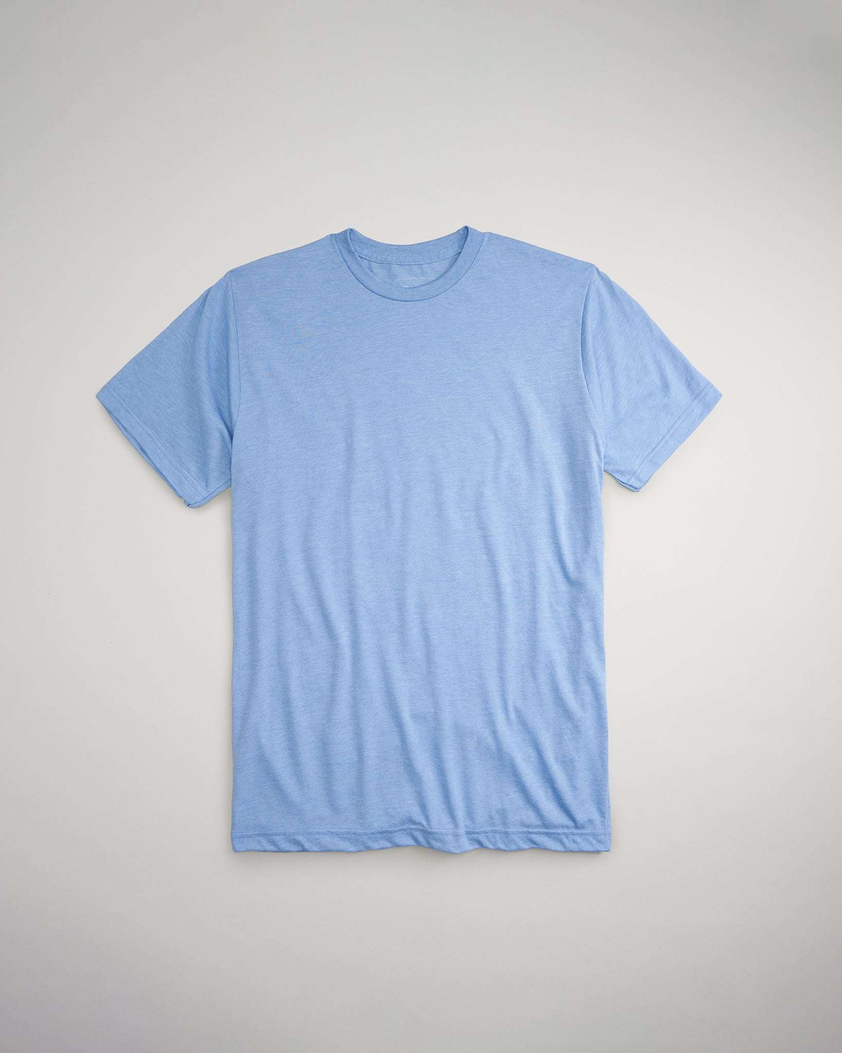 A folded blue t-shirt displayed on a light gray background showcasing a casual and comfortable style