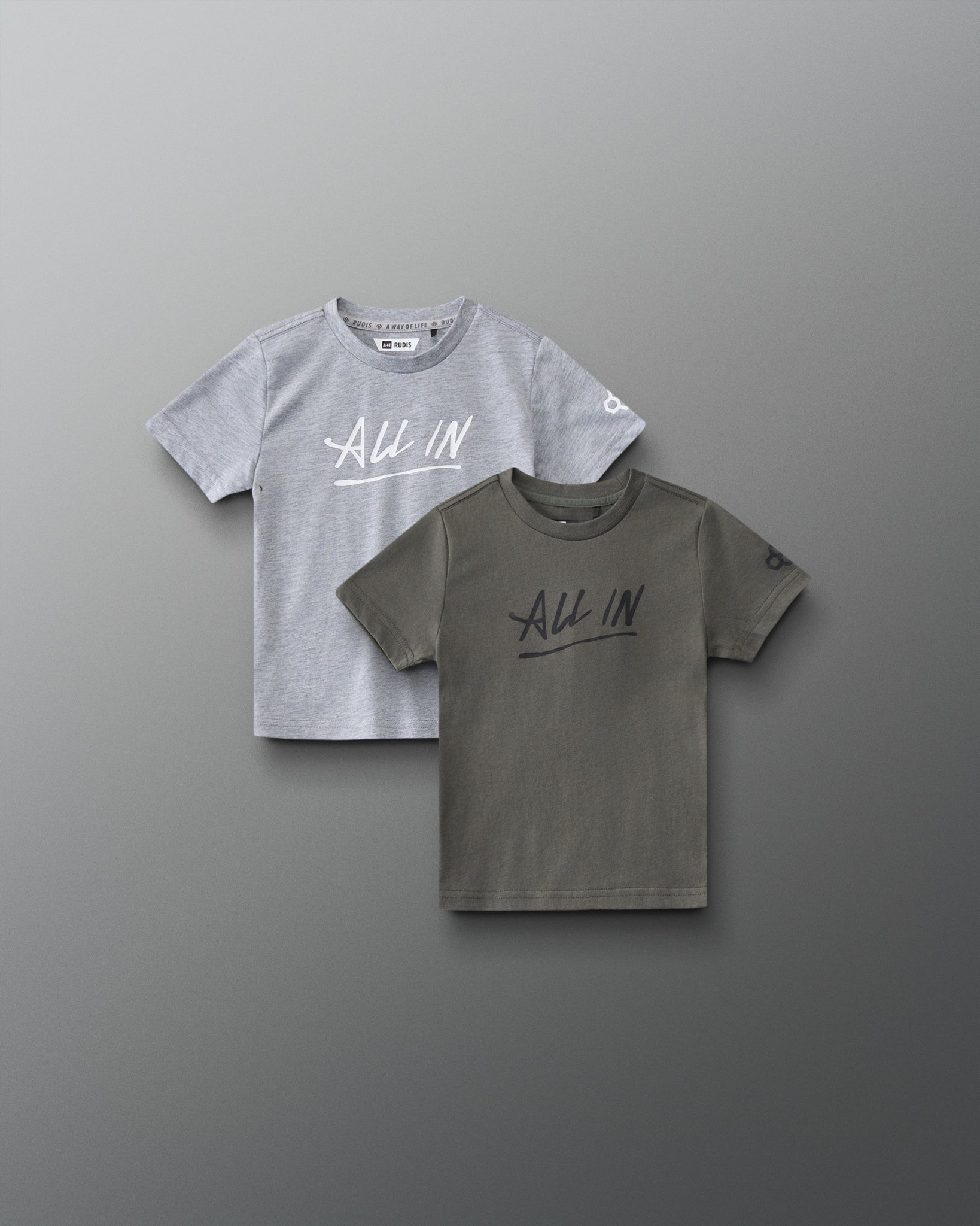 Front view of RUDIS Motto Scripted Toddler Elite Super Soft T-Shirt 2-Pack in olive and gray, featuring ALL IN chest graphics and RUDIS sleeve logos.