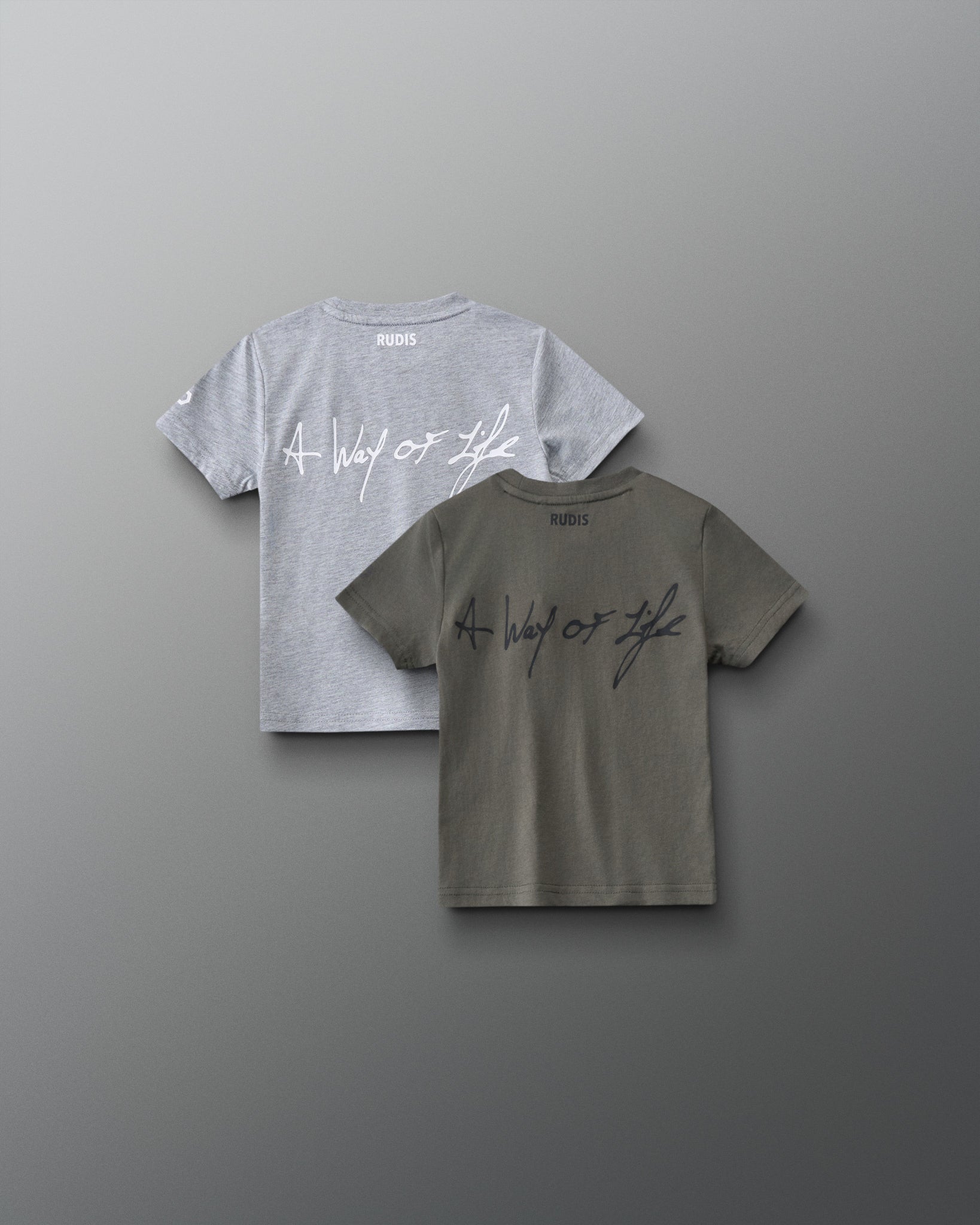 Back view of RUDIS Motto Scripted toddler t-shirts in olive and gray, featuring A Way of Life script graphics and RUDIS branding below the neckline.