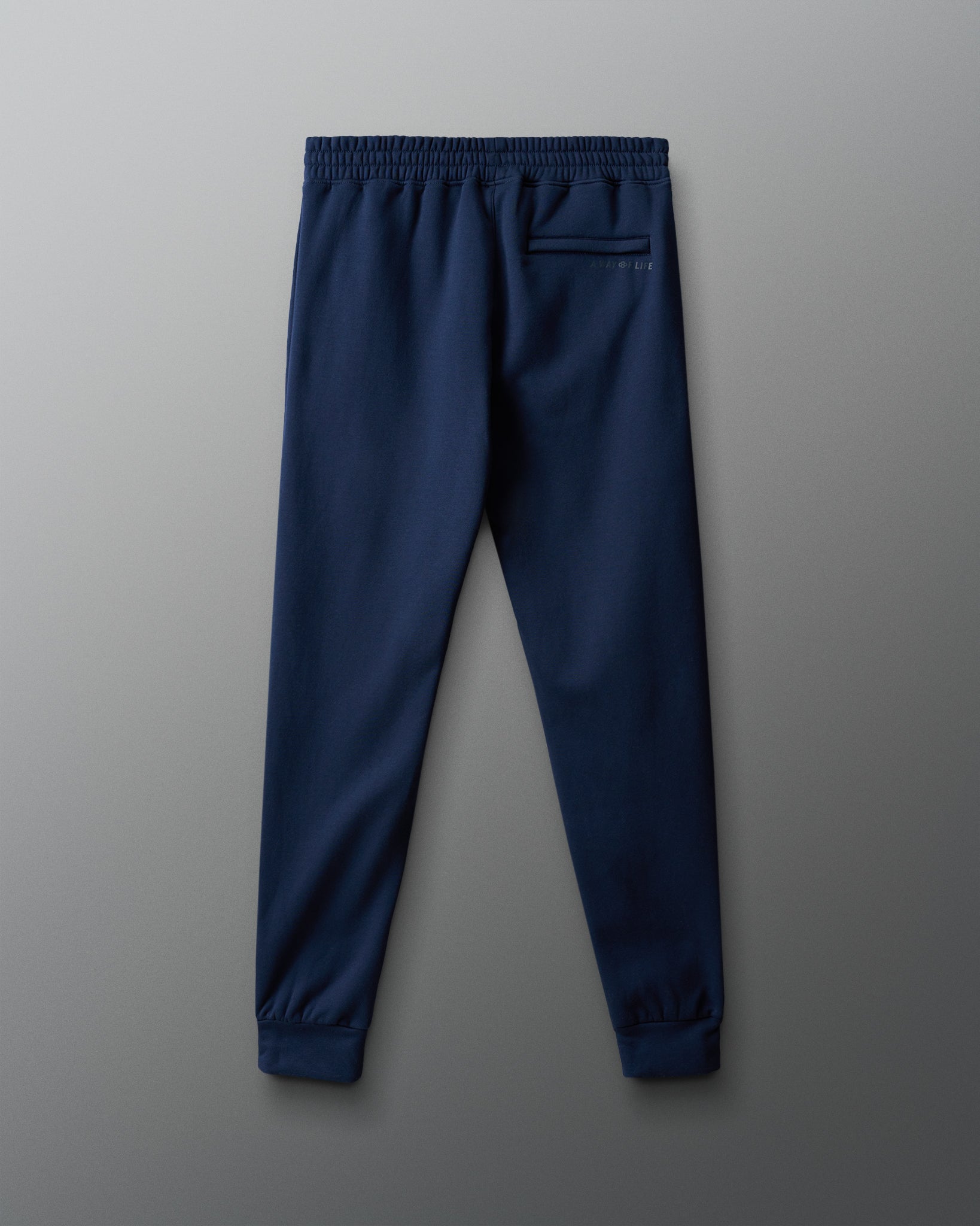 Navy blue jogger pants on a gray background