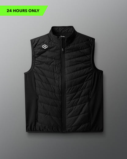 Black quilted vest with a brand logo on a gray background