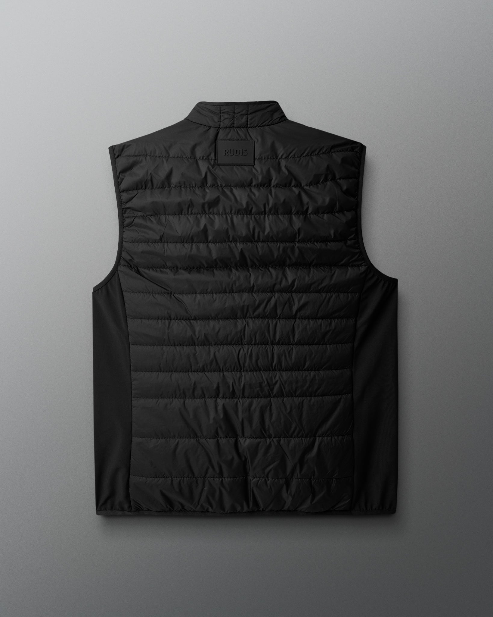 Black puffer vest on a light gray background