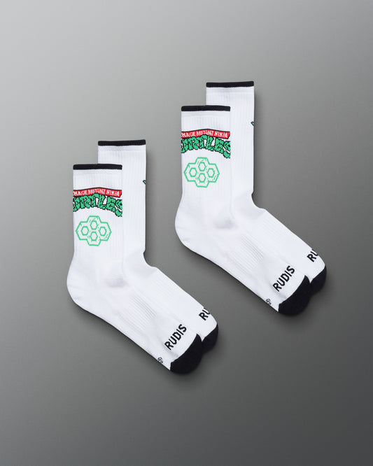 White socks with green and black text on a gray background. TMNT. Teenage Mutant Ninja Turtles